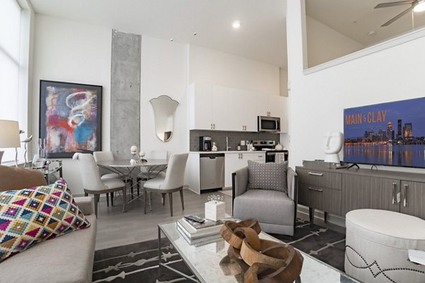Clubhouse offering modern design and spacious lounge at Main & Clay Apartments in Louisville