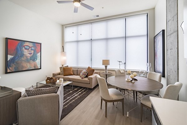 Dining room featuring modern decor and sleek furniture in Main & Clay Apartments, offering a luxurious living experience