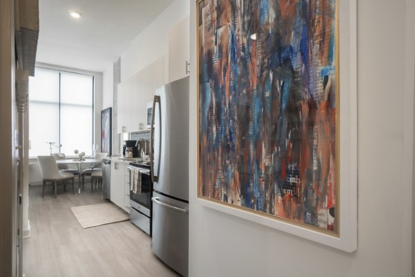 Modern kitchen with sleek countertops and stainless steel appliances in Main & Clay Apartments
