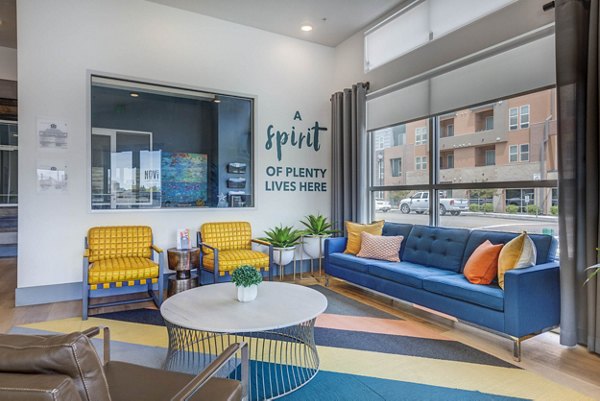 Clubhouse featuring modern design and ample seating at Novi at Jordan Valley Station Apartments