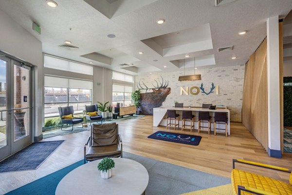 Clubhouse featuring a modern design and communal seating at Novi at Jordan Valley Station Apartments