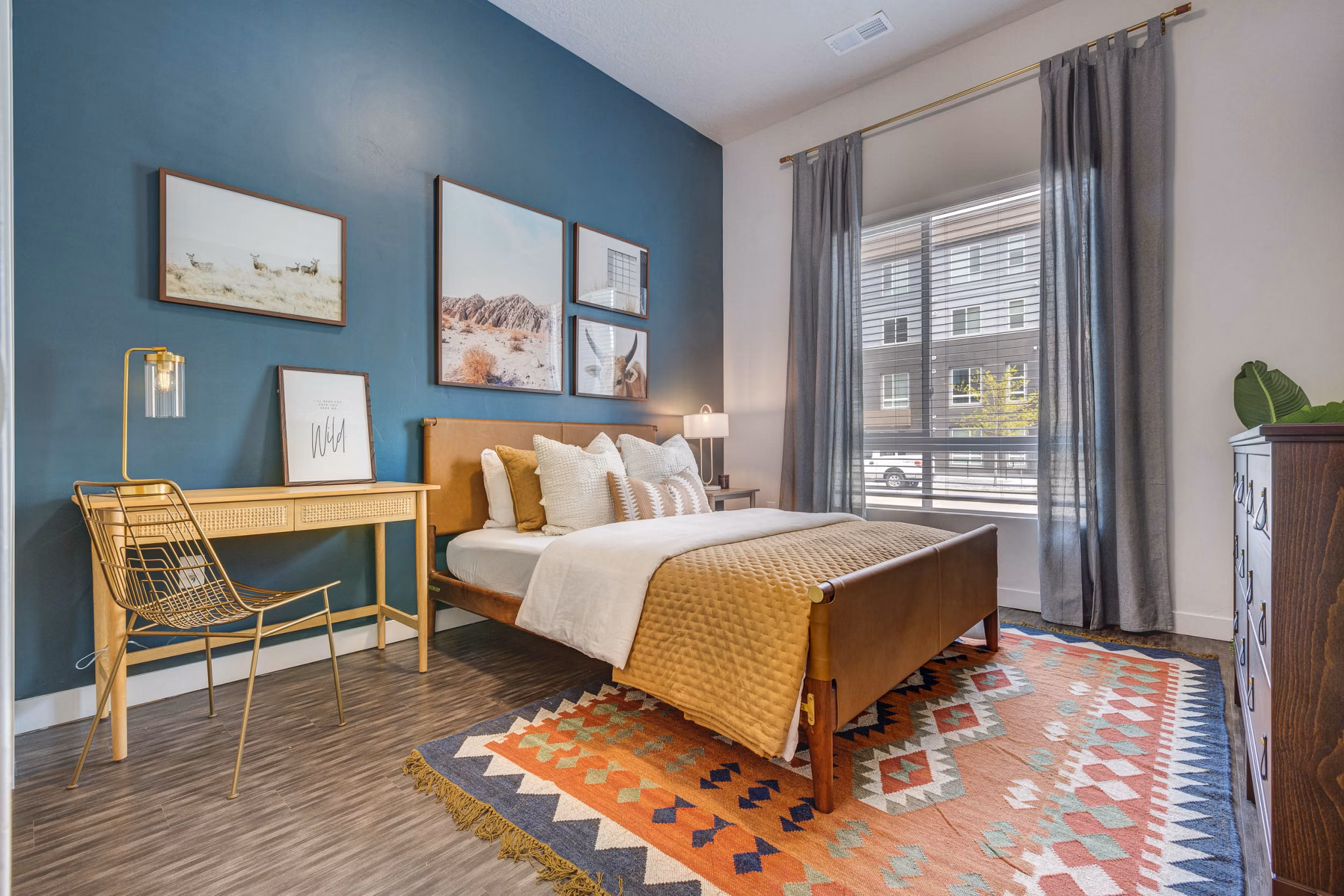 Cozy bedroom with modern design at Novi at Jordan Valley Station Apartments, featuring stylish decor and ample natural light for a luxurious living experience