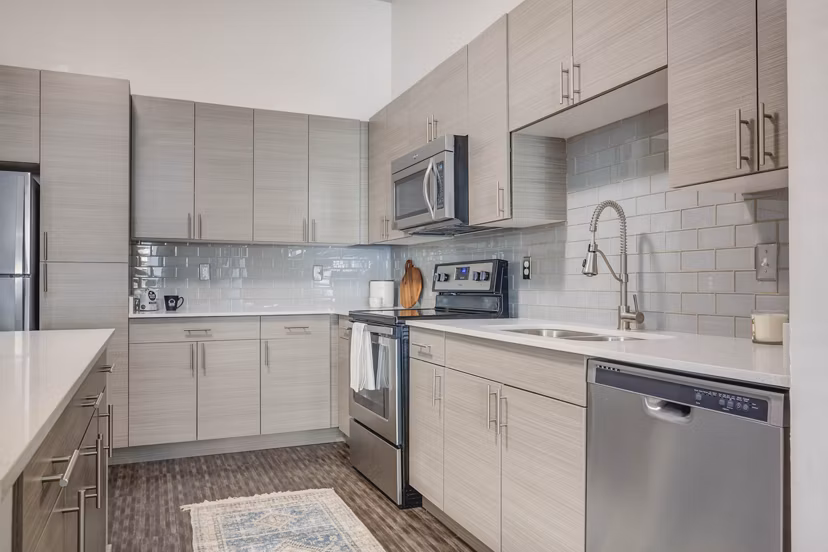 Modern kitchen with stainless steel appliances at Novi at Jordan Valley Station Apartments, luxury living near public transit