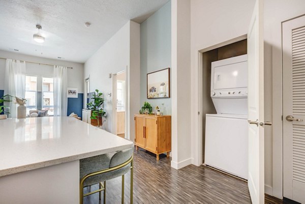 Spacious laundry room with modern washers and dryers at Novi at Jordan Valley Station Apartments