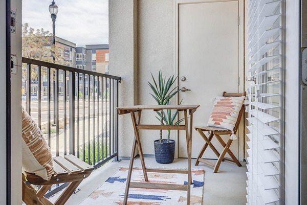 Charming patio with modern seating at Novi at Jordan Valley Station Apartments, perfect for relaxation and outdoor gatherings