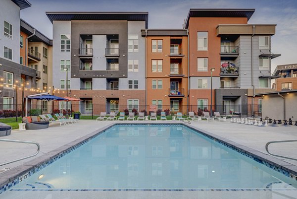 Spacious outdoor pool area at Novi at Jordan Valley Station Apartments, perfect for relaxation and recreation with luxury amenities