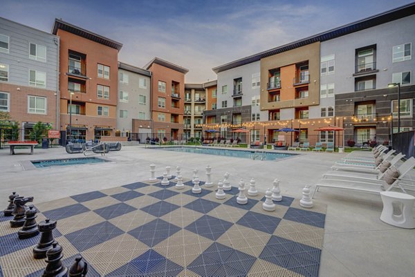 Courtyard with greenery and seating at Novi at Jordan Valley Station Apartments
