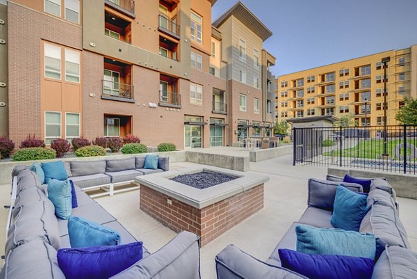 Fire pit lounge area at Novi at Jordan Valley Station Apartments