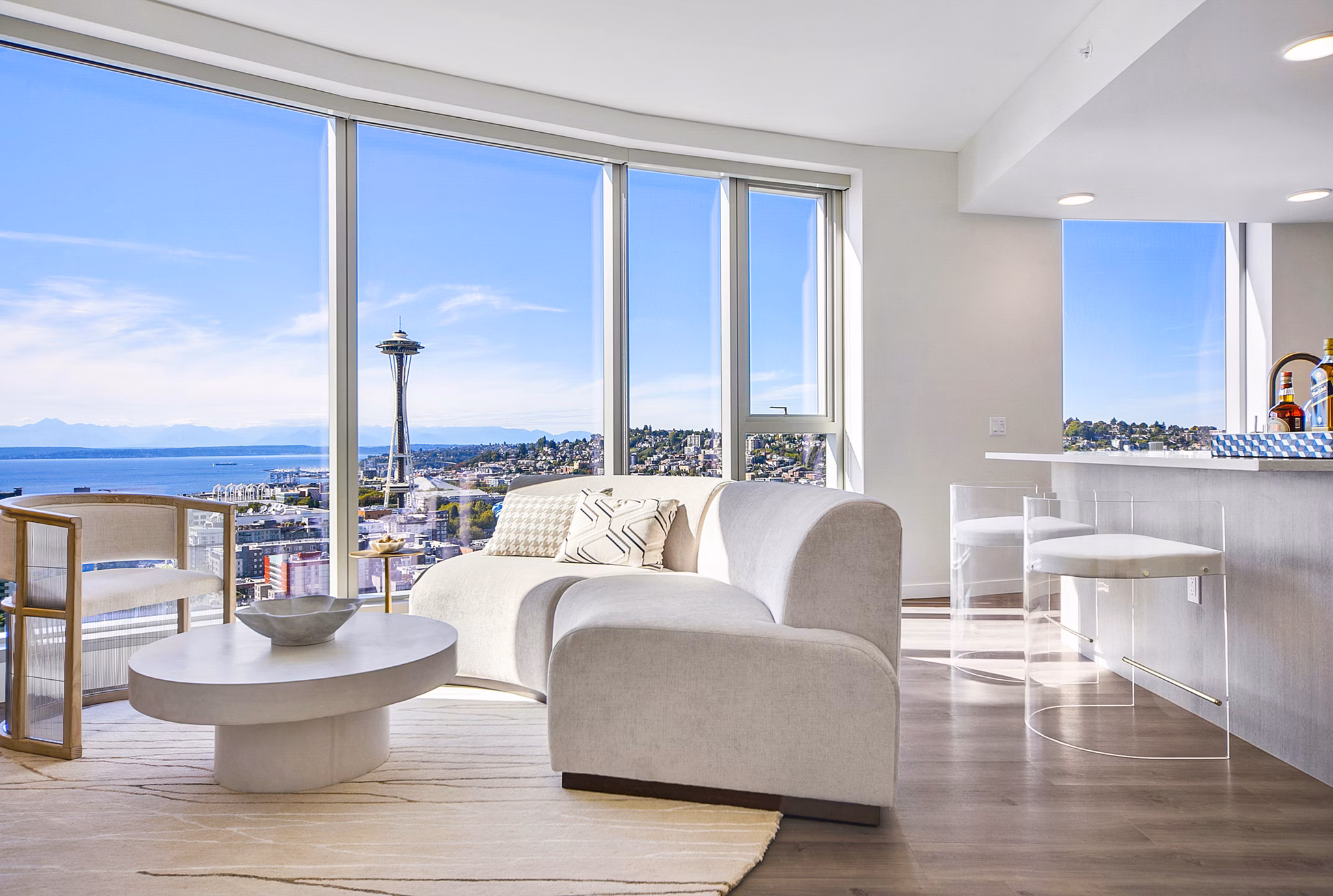 Living room with modern decor and city views in McKenzie Apartments
