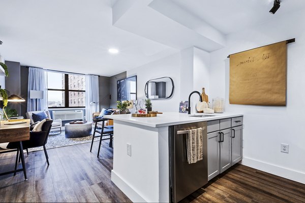 Modern kitchen with sleek countertops and stainless steel appliances at Observer Park Apartments