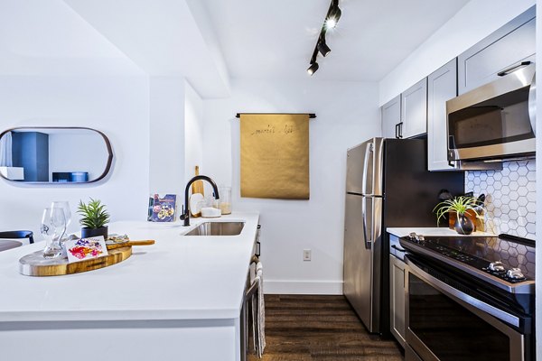 Modern kitchen with stainless steel appliances at Observer Park Apartments