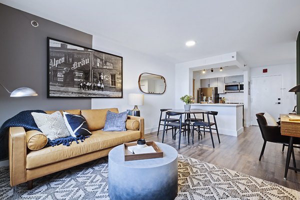 Modern living room with stylish furnishings and natural light at Observer Park Apartments