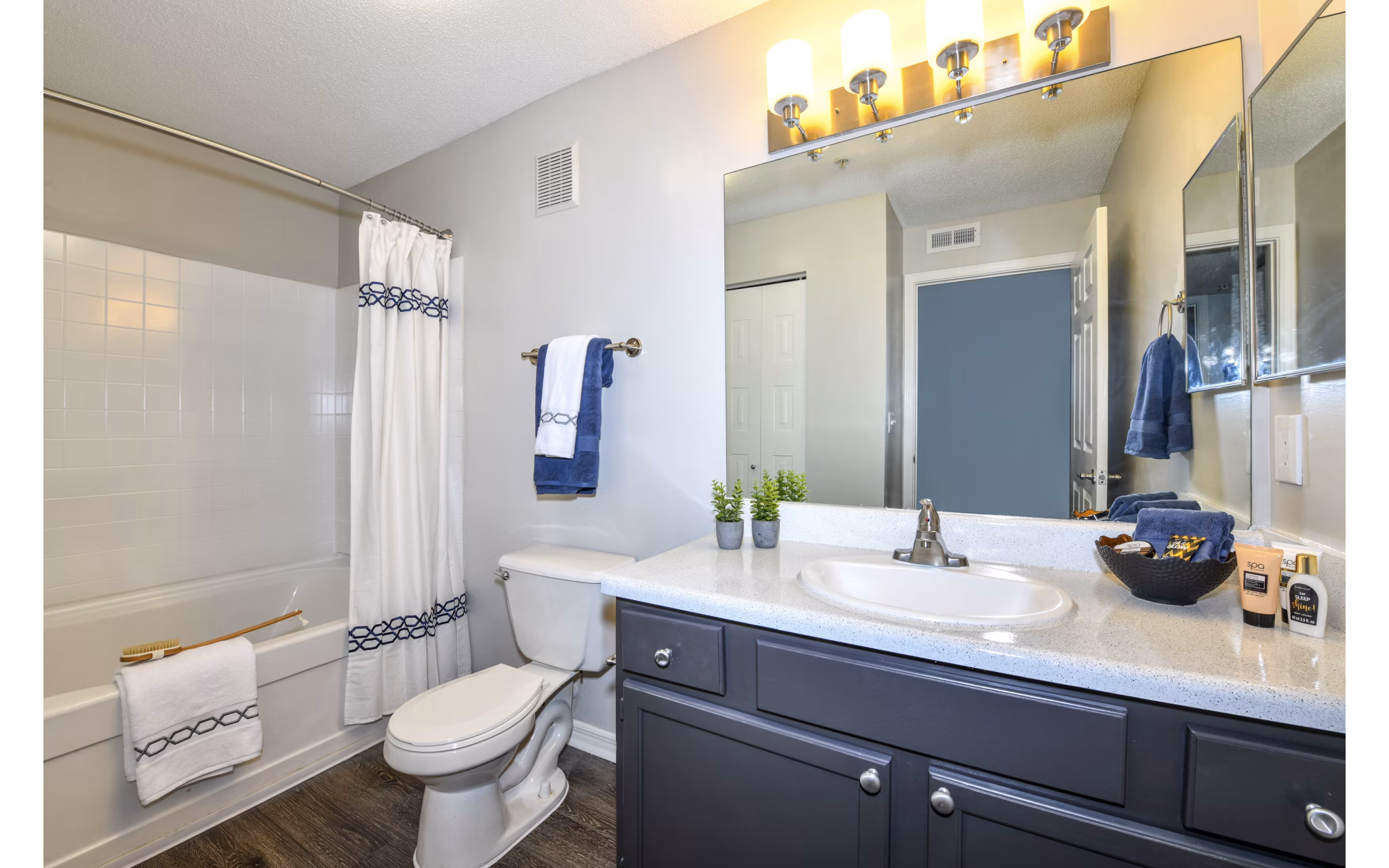 Modern bathroom with marble countertops and sleek fixtures at The Palmer Apartments, offering luxury living in the heart of the city