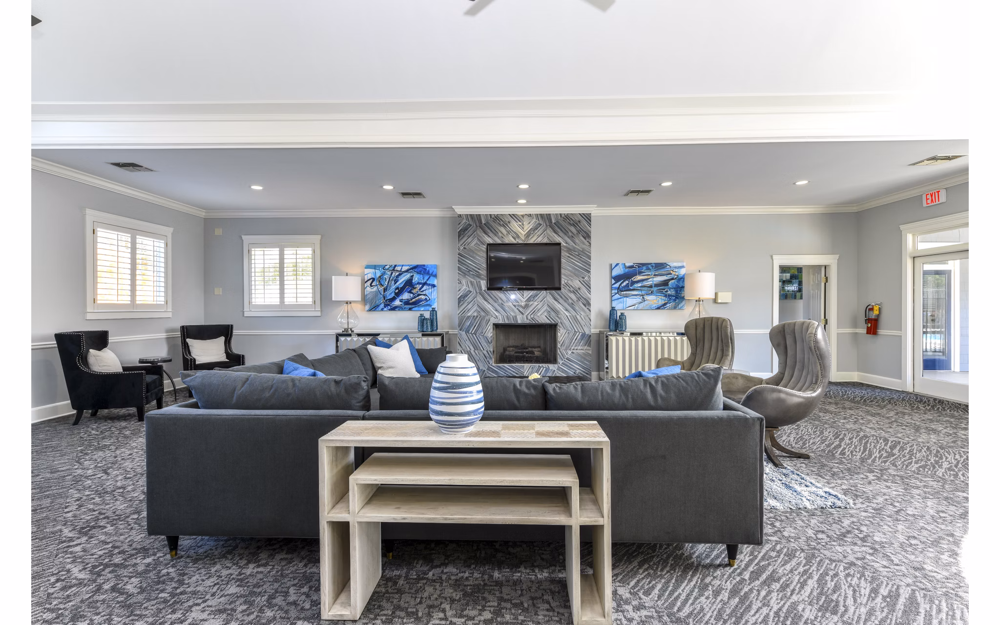 Modern clubhouse with cozy seating and large windows at The Palmer Apartments