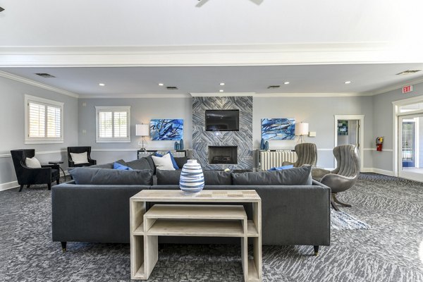 Modern clubhouse with cozy seating and large windows at The Palmer Apartments