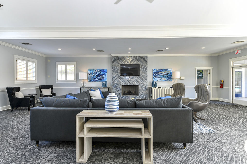 Modern clubhouse with cozy seating and large windows at The Palmer Apartments