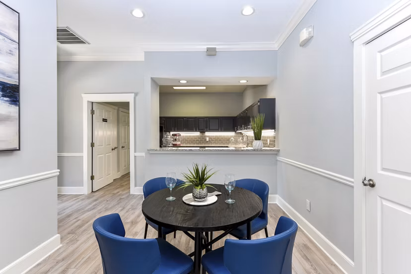 Dining area with modern furnishings and stylish lighting at The Palmer Apartments