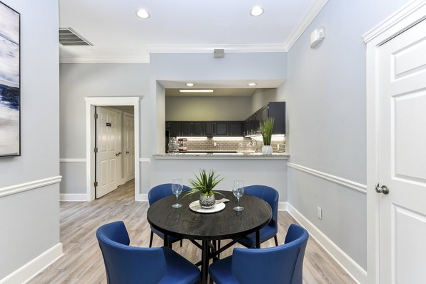 Dining area with modern furnishings and stylish lighting at The Palmer Apartments