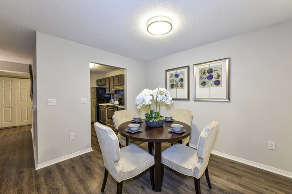 Dining area with modern furniture and warm lighting in The Palmer Apartments