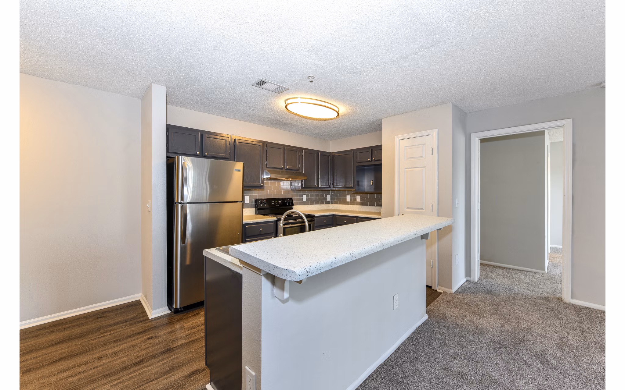 Modern kitchen with stainless steel appliances at The Palmer Apartments