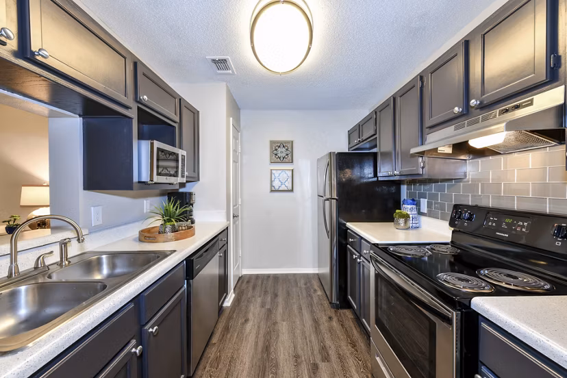 Contemporary kitchen with stainless steel appliances at The Palmer Apartments