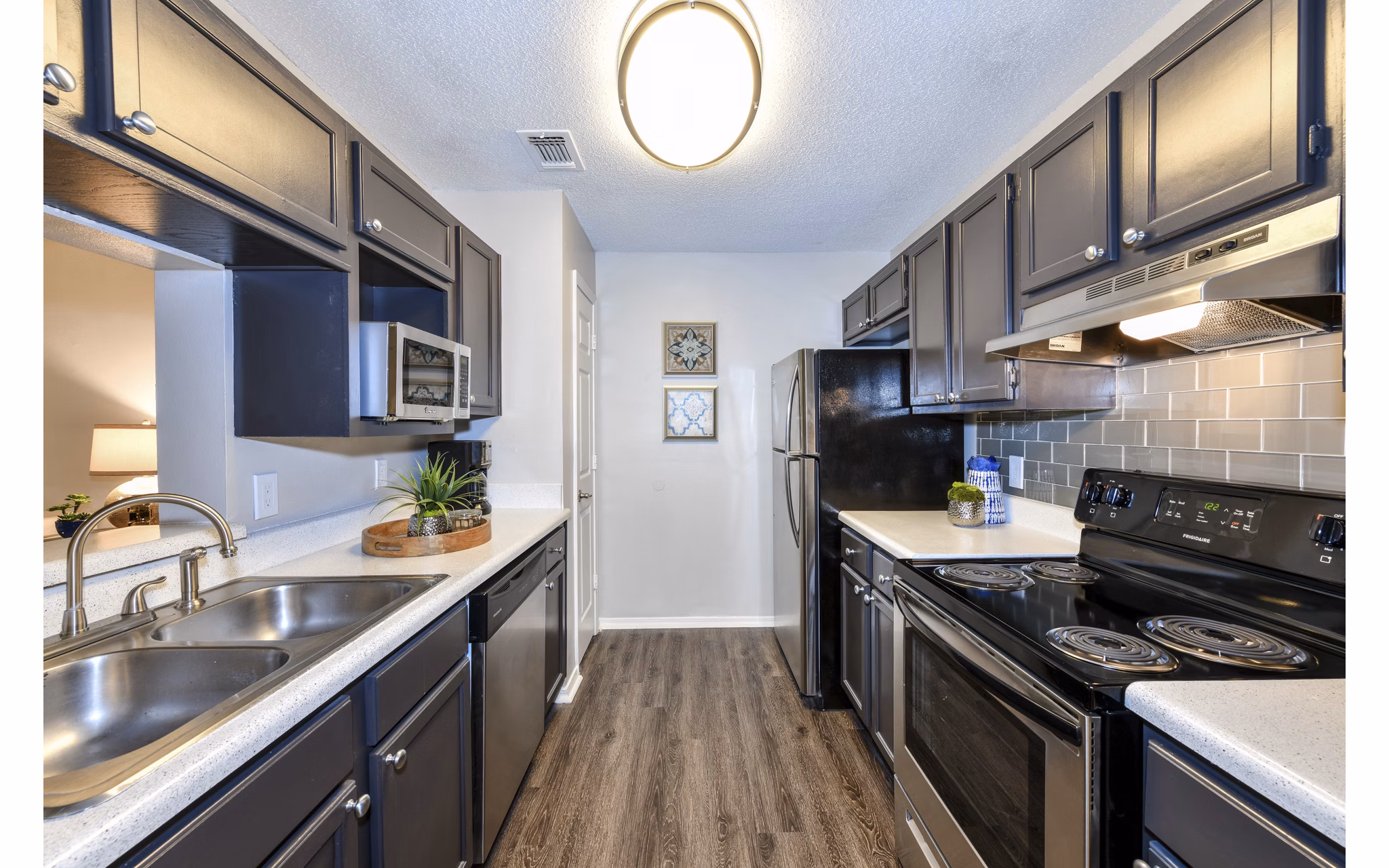 Contemporary kitchen with stainless steel appliances at The Palmer Apartments