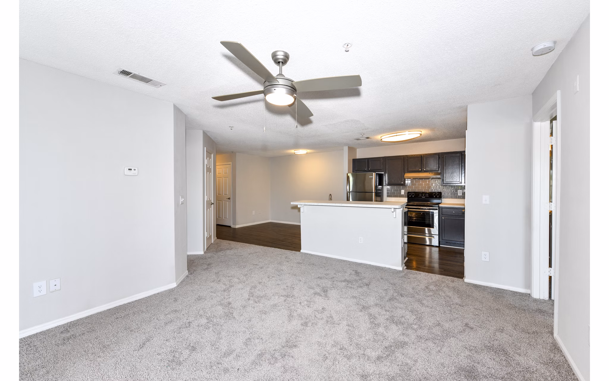 Modern living room with stylish furnishings and large windows at The Palmer Apartments, a premier luxury community
