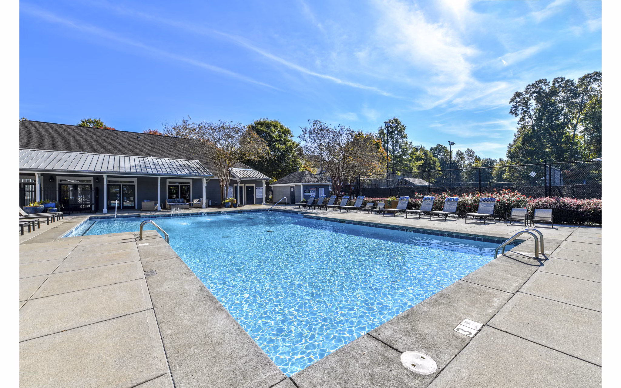 Modern pool with sun loungers at The Palmer Apartments, ideal for relaxation and leisure in a luxury setting