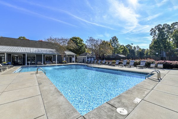 Modern pool with sun loungers at The Palmer Apartments, ideal for relaxation and leisure in a luxury setting