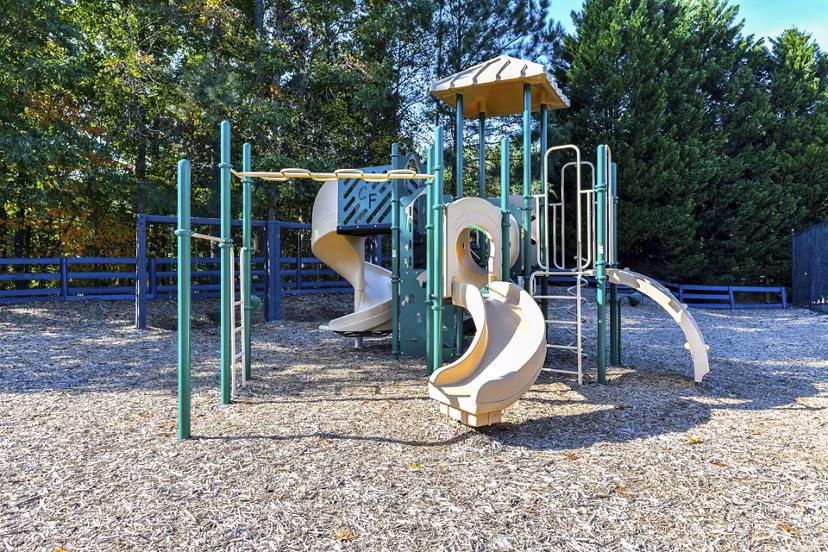 Outdoor playground featuring modern equipment at The Palmer Apartments