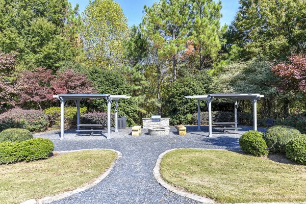 Outdoor grill area with modern seating at The Palmer Apartments, a luxurious community offering premium amenities located in a prime urban setting