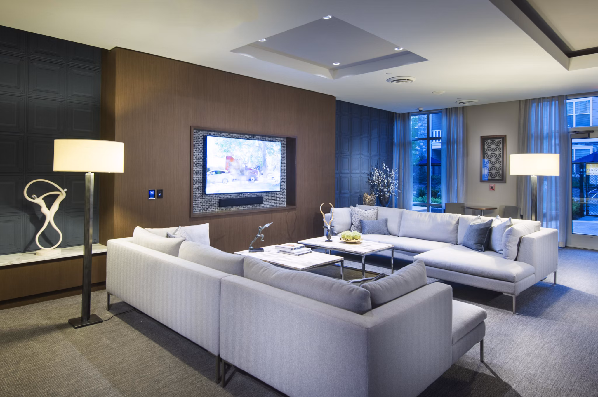 Clubhouse at Marq at the Pinehills Apartments featuring cozy seating and modern decor for residents' relaxation and social gatherings