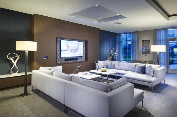 Clubhouse at Marq at the Pinehills Apartments featuring cozy seating and modern decor for residents' relaxation and social gatherings