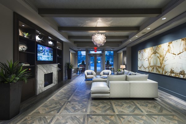 Elegant clubhouse with cozy seating and fireplace at Marq at the Pinehills Apartments
