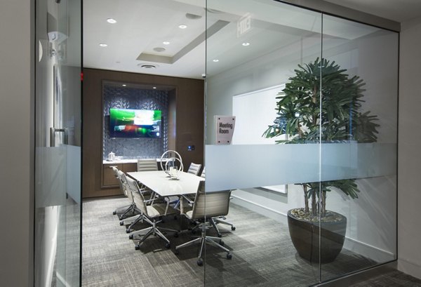 Meeting room equipped with modern technology and seating at Marq at the Pinehills Apartments, ideal for business gatherings and events