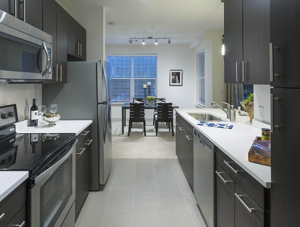 Modern kitchen with stainless steel appliances at Marq at the Pinehills luxury apartments