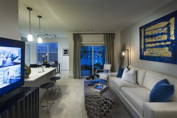 Cozy living room with elegant furnishings at Marq at the Pinehills Apartments