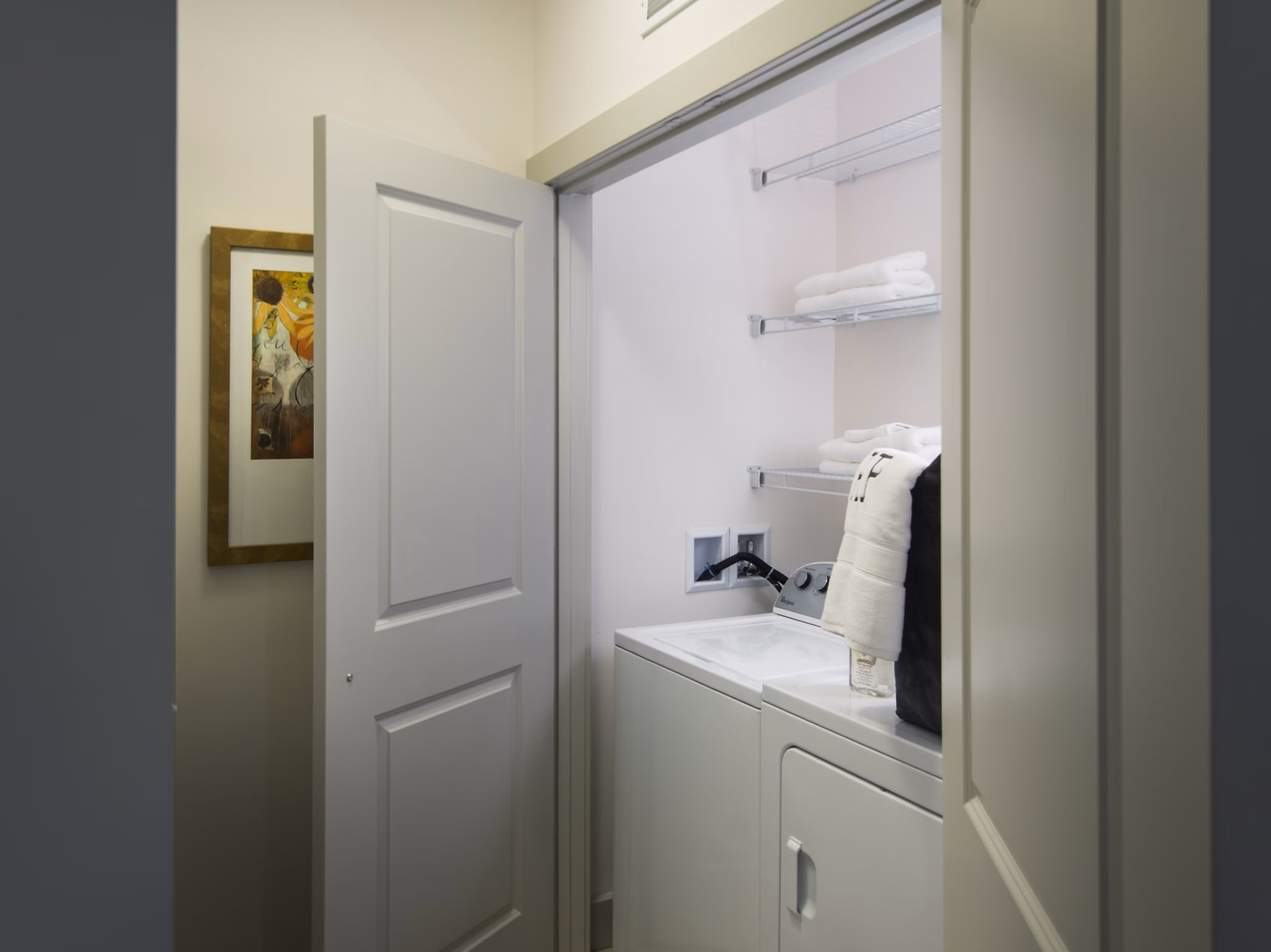 Laundry room featuring state-of-the-art appliances in Marq at the Pinehills Apartments