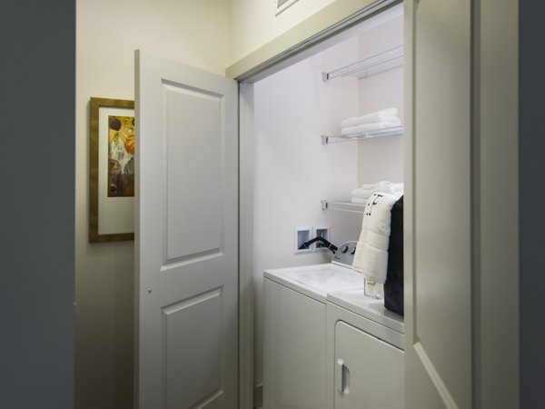 Laundry room featuring state-of-the-art appliances in Marq at the Pinehills Apartments