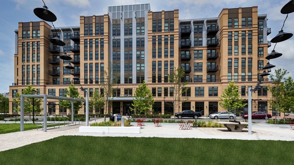 Luxury apartment building with landscaped area and seating in front