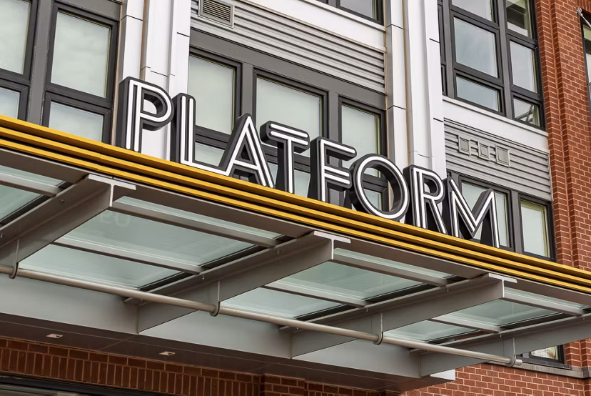 PLATFORM luxury apartments with a glass awning and modern architecture in an urban setting