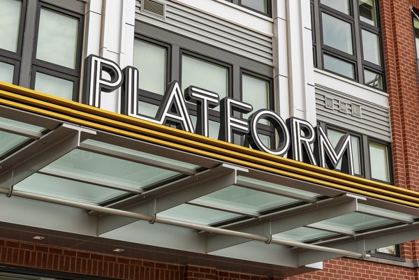 PLATFORM luxury apartments with a glass awning and modern architecture in an urban setting