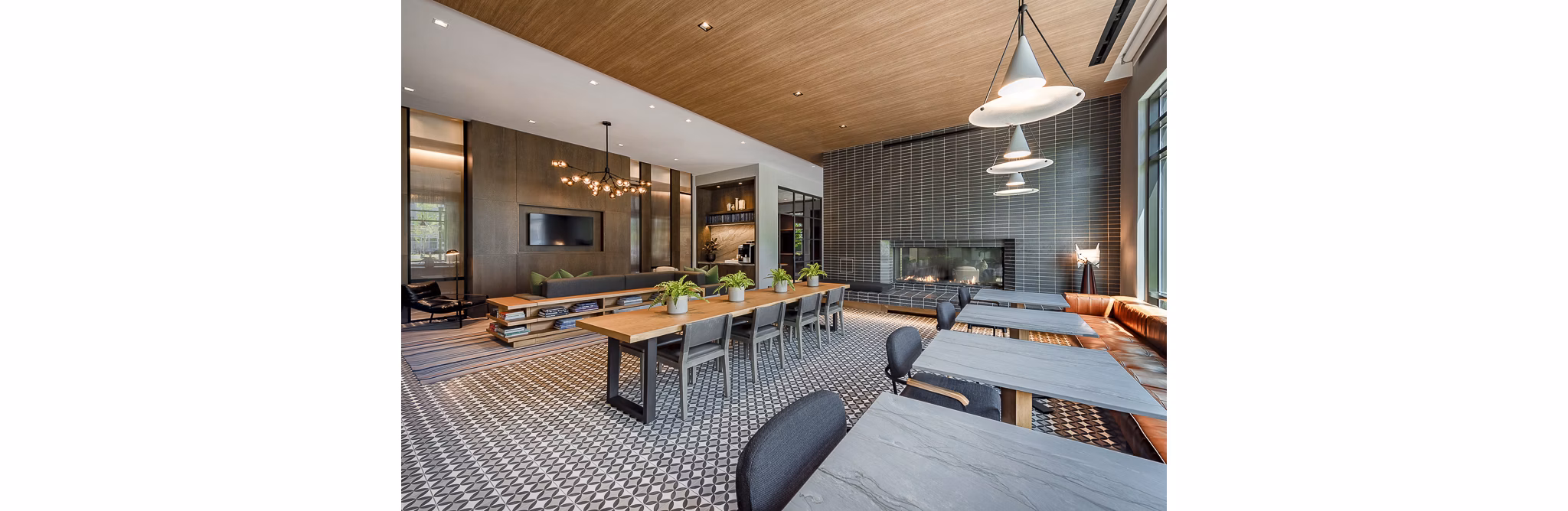 Stylish lounge area with tables and chairs, featuring a fireplace and decorative lighting in luxury apartments
