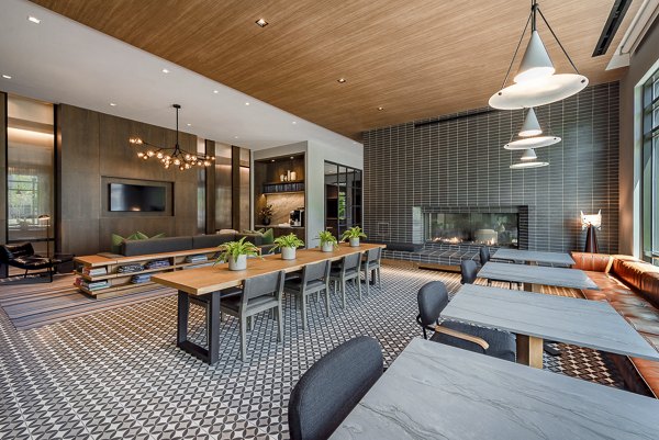 Stylish lounge area with tables and chairs, featuring a fireplace and decorative lighting in luxury apartments