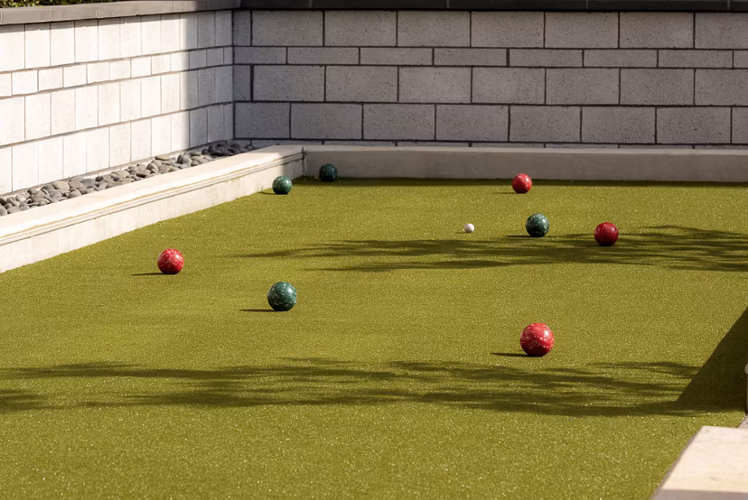 Bocce ball court with colorful balls ready to play at luxury apartments