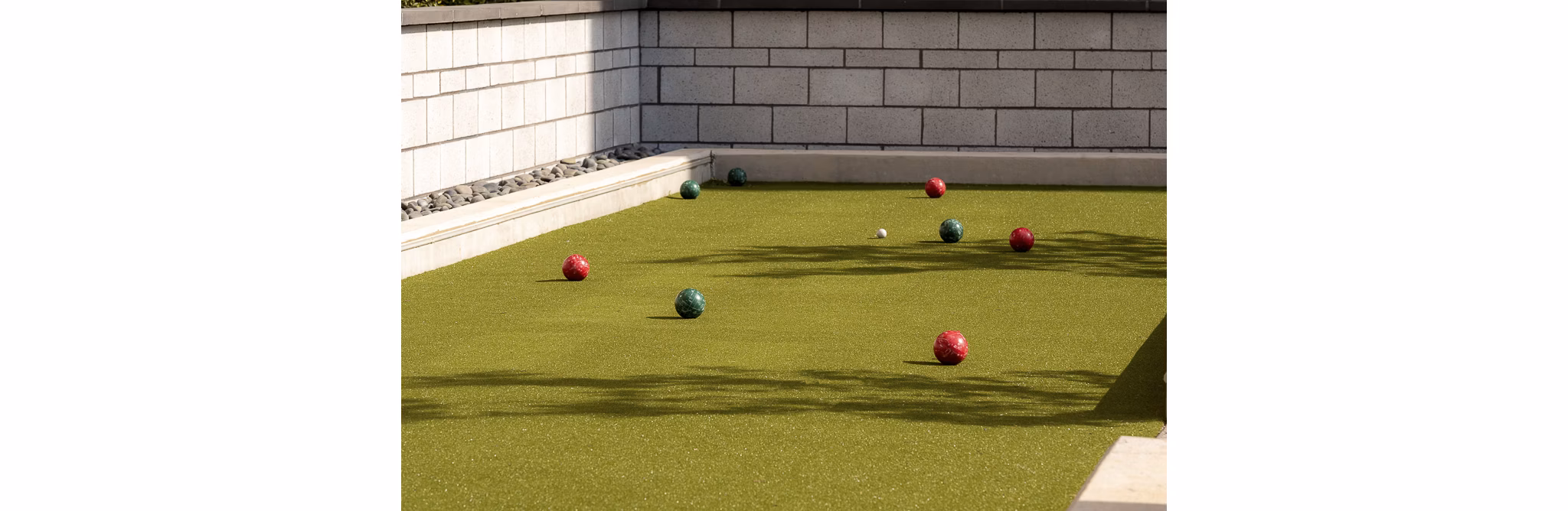 Bocce ball court with colorful balls ready to play at luxury apartments