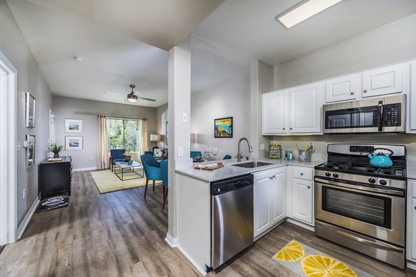 Modern kitchen with stainless steel appliances at Overture Rancho Santa Margarita Active Adult Apartments