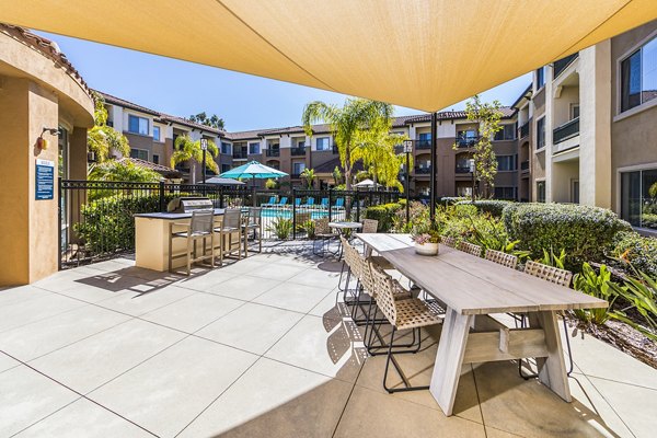 Outdoor grill area at Overture Rancho Santa Margarita Active Adult Apartments featuring modern amenities