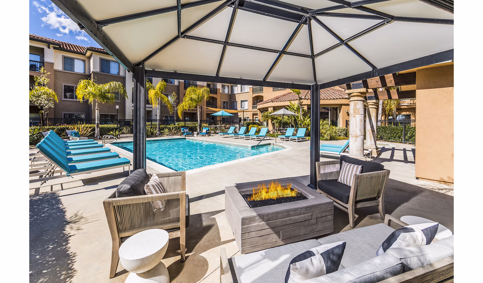 Serene outdoor pool at Overture Rancho Santa Margarita Active Adult Apartments surrounded by lush greenery