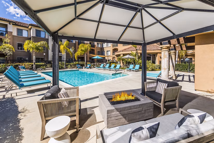 Serene outdoor pool at Overture Rancho Santa Margarita Active Adult Apartments surrounded by lush greenery